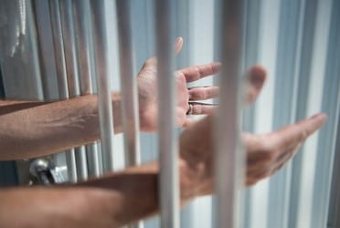 imprisoned man outstretches arms through 260nw 426925732 1