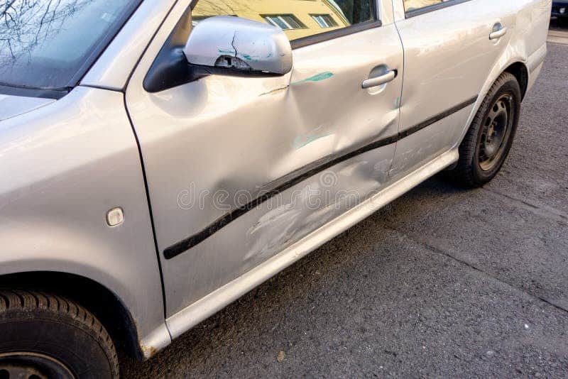 coche azul claro danado en un accidente de trafico leve con neumatico plano waitng del que se reparara 143059160