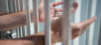 imprisoned man outstretches arms through 260nw 426925732 3